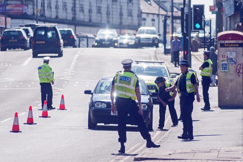Police stopping cars in traffic